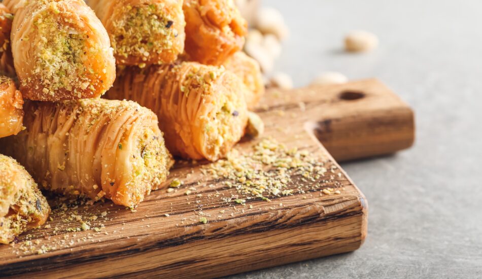 Wooden,Board,With,Delicious,Baklava,On,Grey,Background,,Closeup